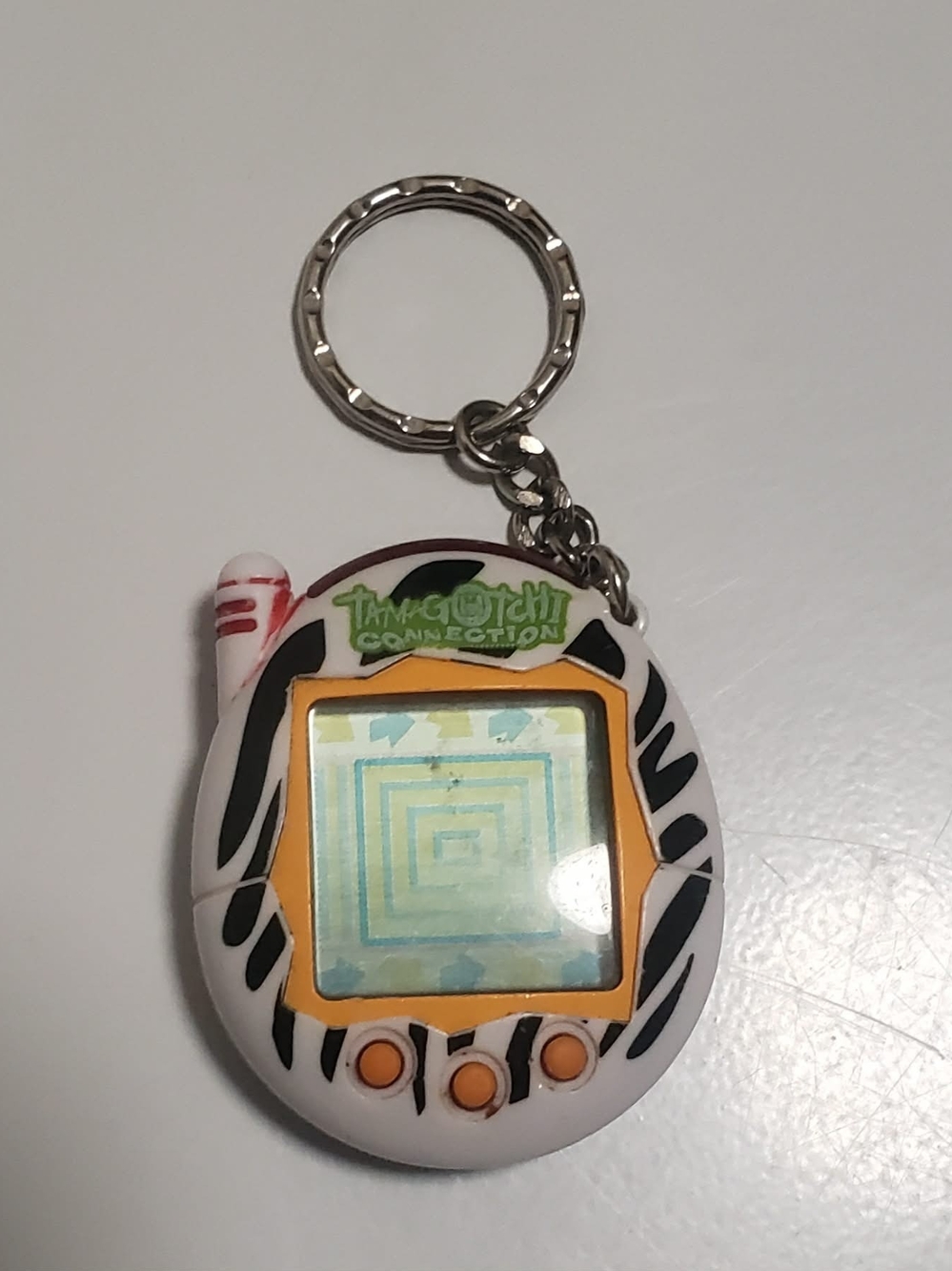Tamagotchi Connection Keychain - White with Black Zebra Stripes & Orange Accents